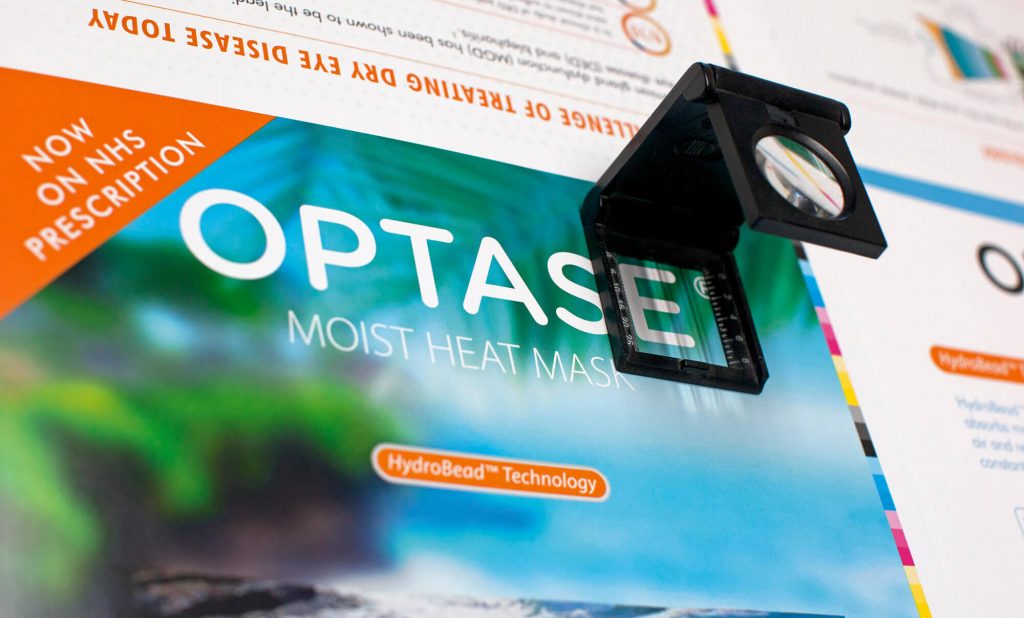 A magnifying lens over a printed leaflet.